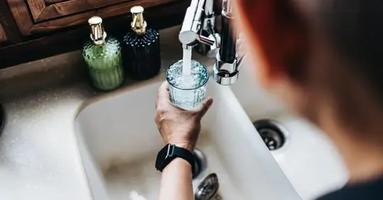 Filling glass with tap water
